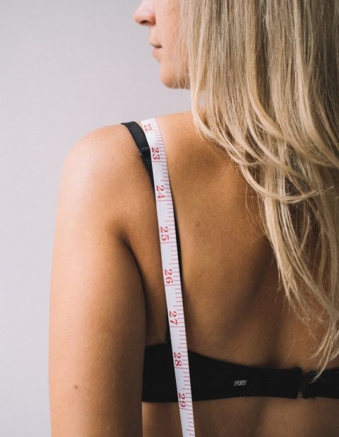 Photo of a Tape Measure on a Woman's Back